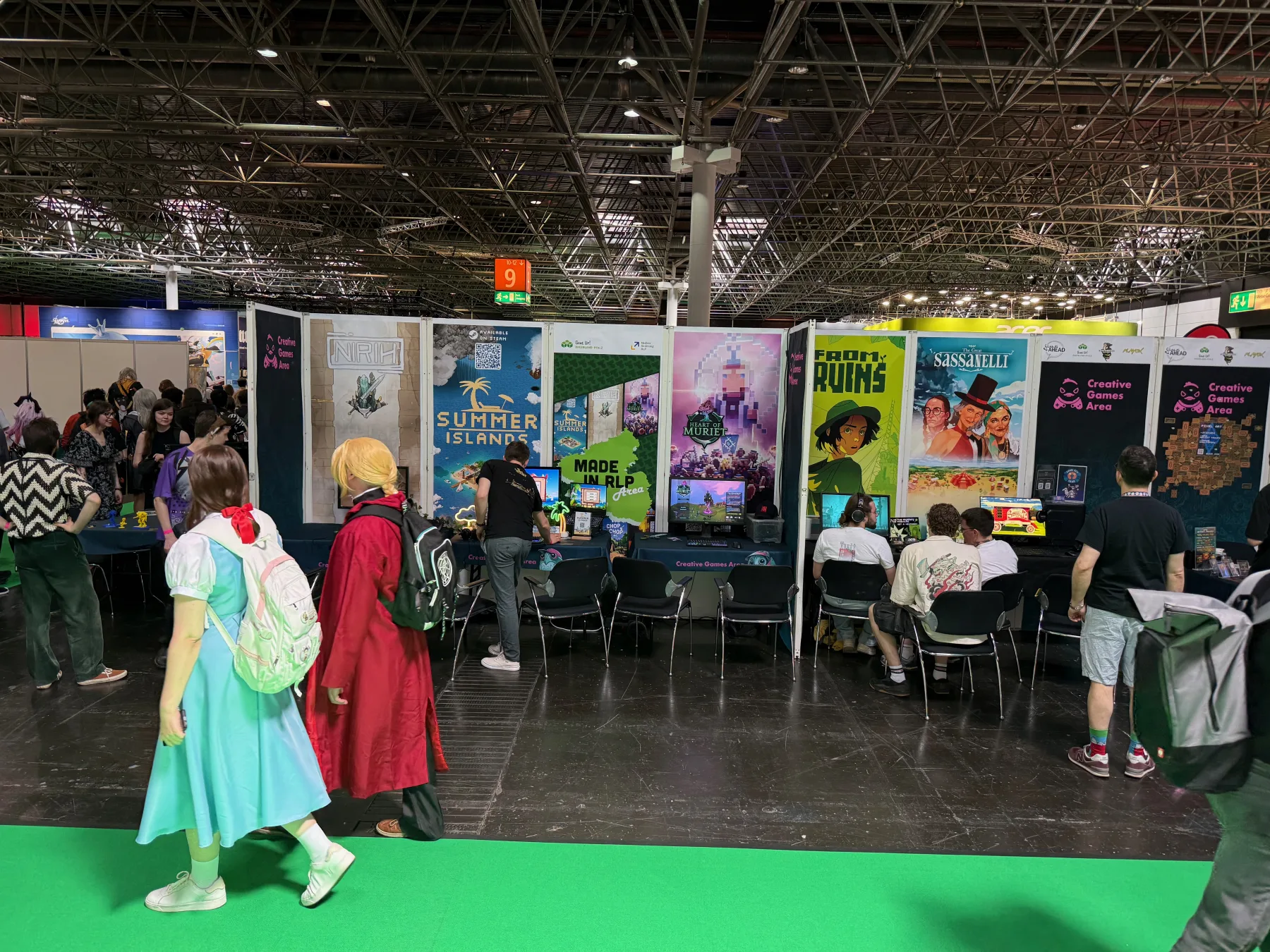 The Creative Games Area booth at DoKomi with the Heart of Muriet banner and visitors passing by